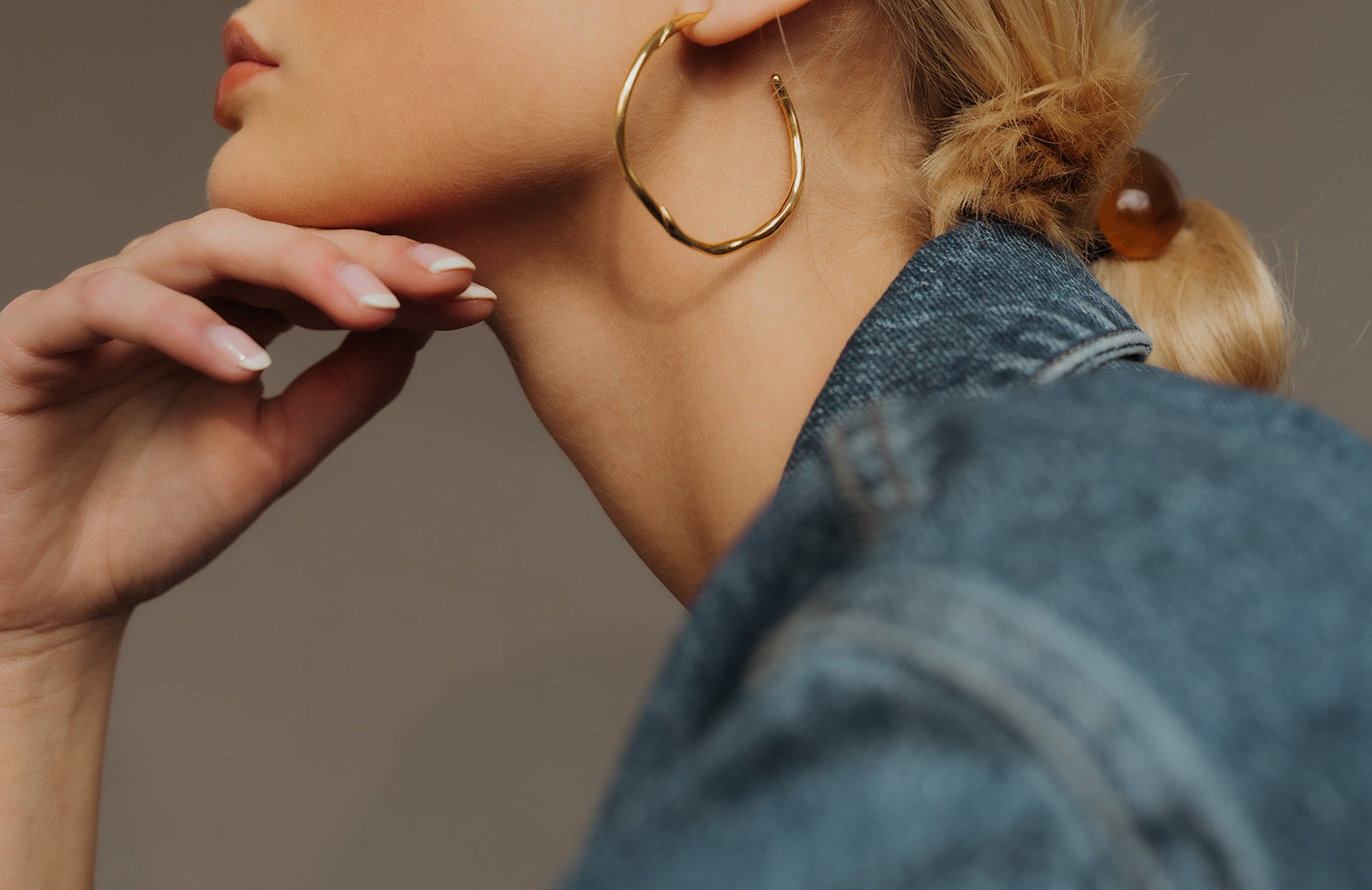 girl with nails and blonde hair gold earrings