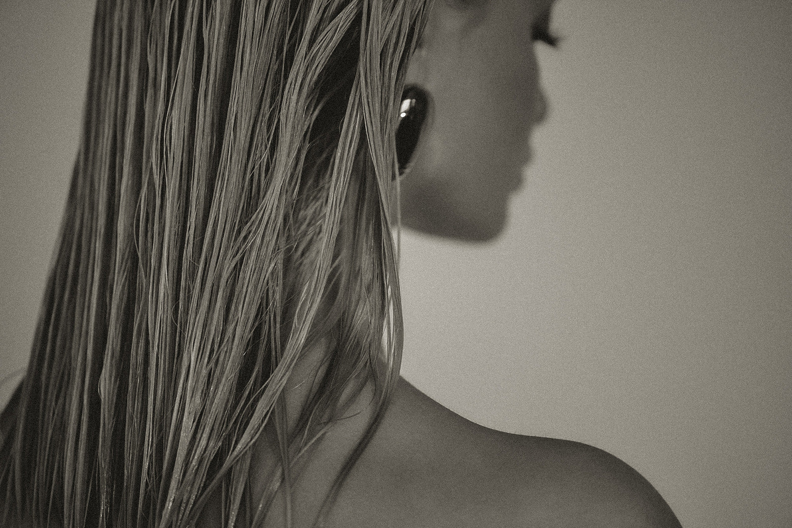 Black and white close-up of a person's shoulder and hair cut walnut creek ca 